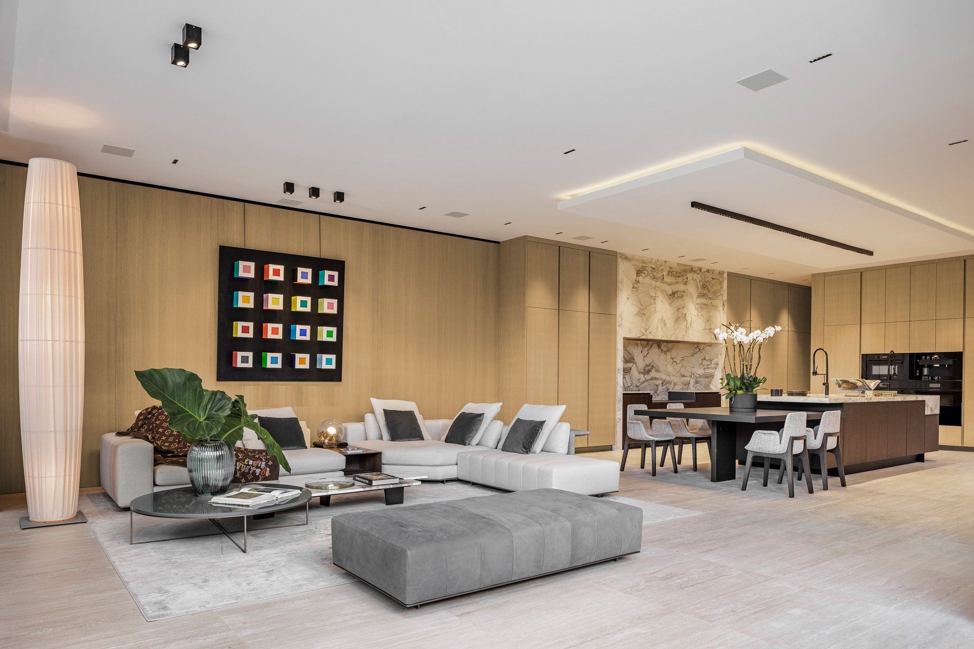 Elegant living room with custom European millwork next to kitchen with Italian cabinetry
